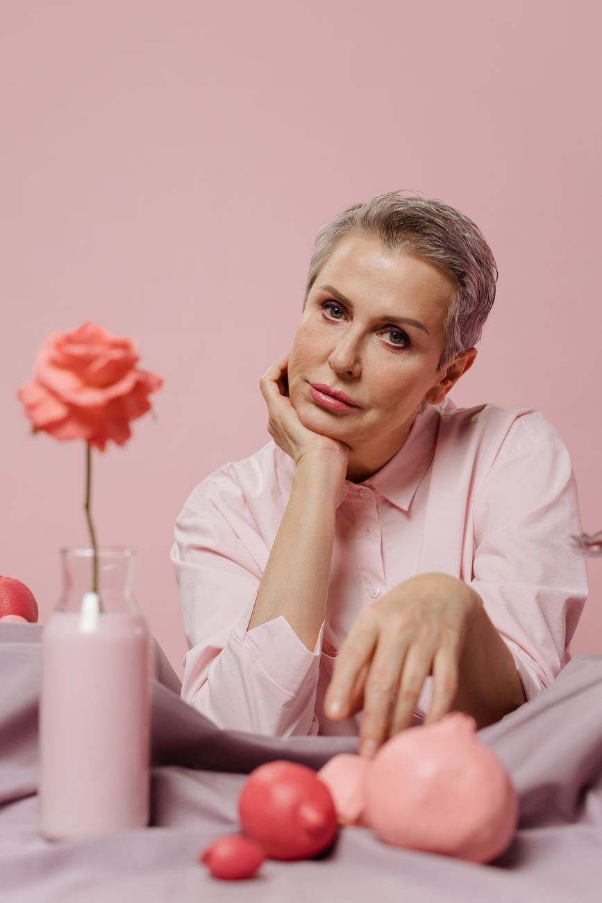 a beautiful woman posing in pink long sleeve shirt